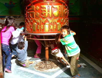 God Dieux ~ God Dieux Photography ~ Tibetan Children Playing on Large Prayer Wheel ~ God Dieux Photography